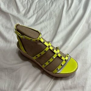 Neon yellow Marc Fisher platform sandals with studs.